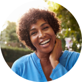 A woman outside smiling at the camera.